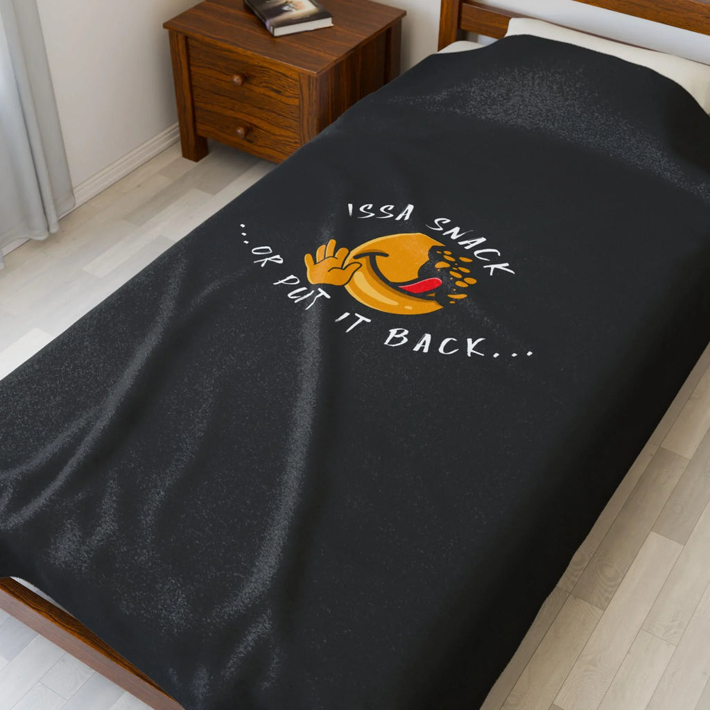 Black blanket with smiley face and 'Issa Snack ...or put it back...' text on bed