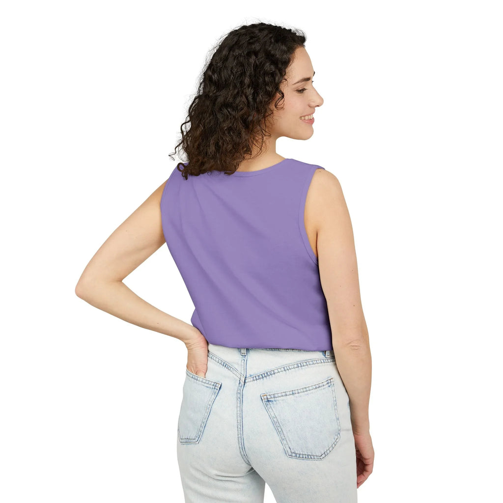 Woman in sleeveless lavender top and light wash jeans facing away on white background