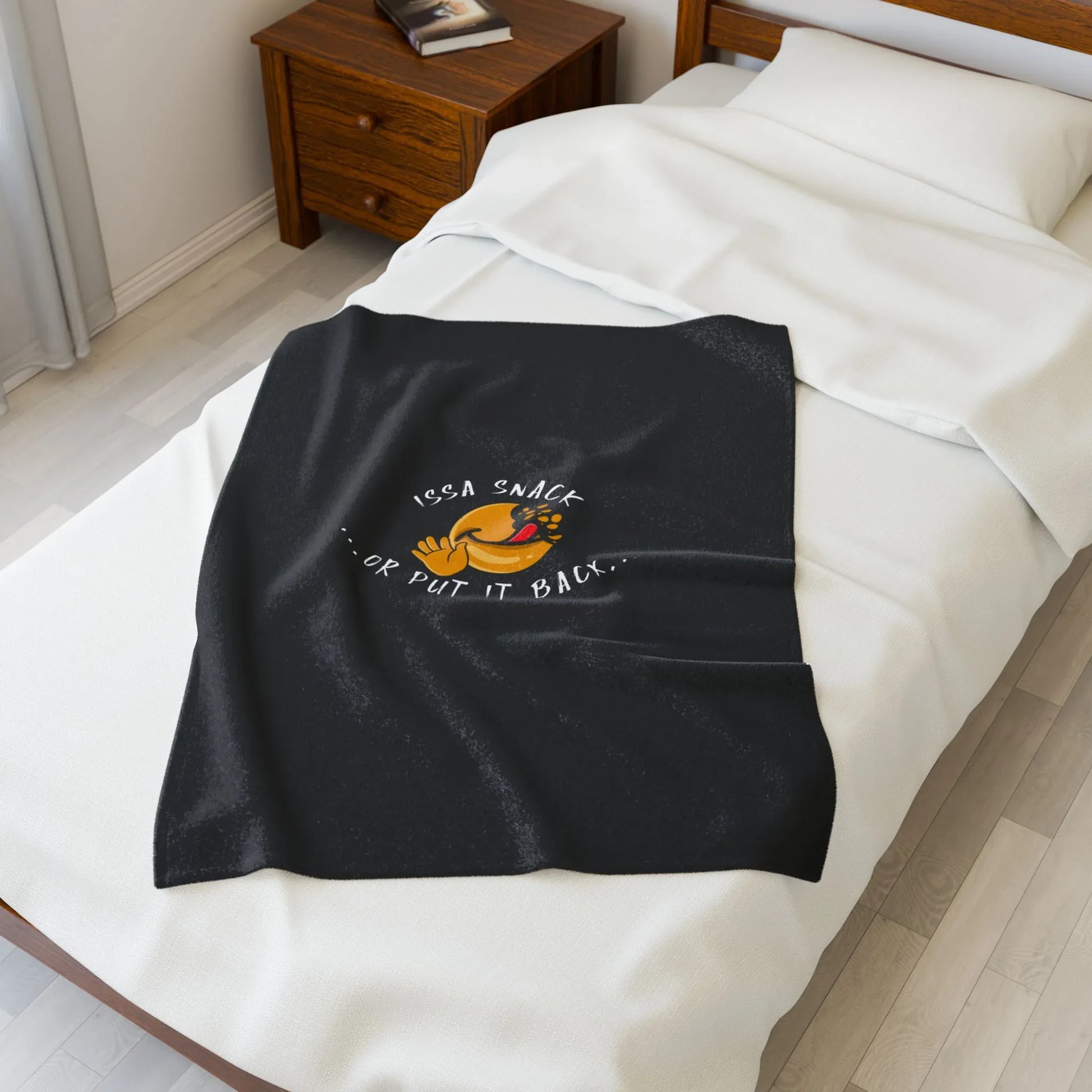 Black throw blanket with snack hand graphic and 'Issa Snack or Put It Back' text on bed
