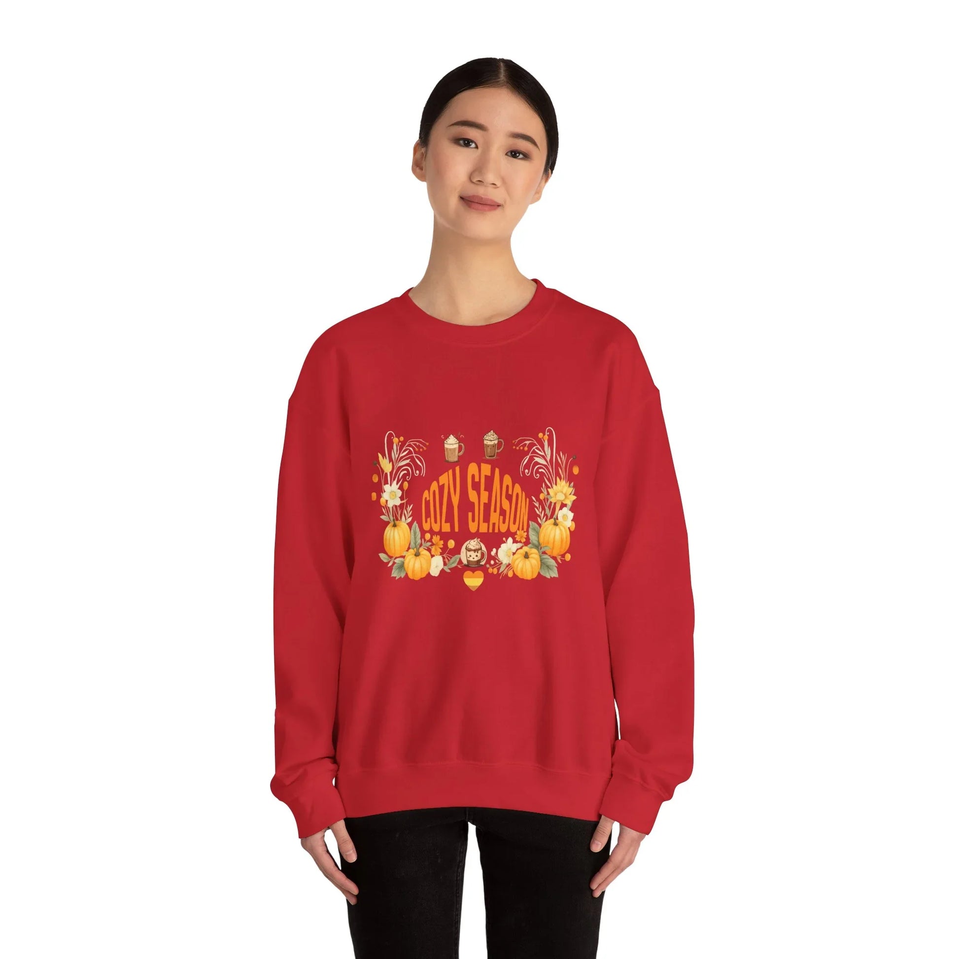 Woman wearing red Cozy Season sweatshirt with fall pumpkins and autumn design