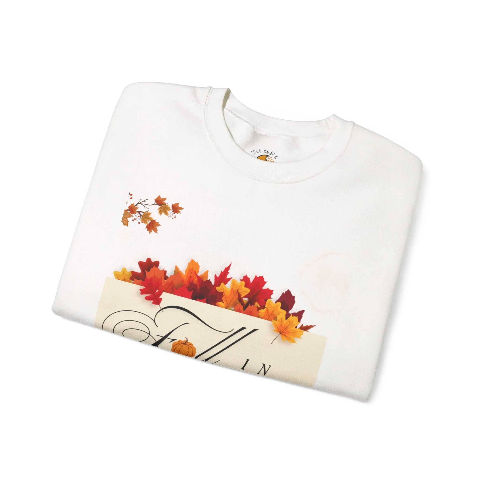 White sweatshirt with fall leaves and autumn-themed print, folded on a white background.