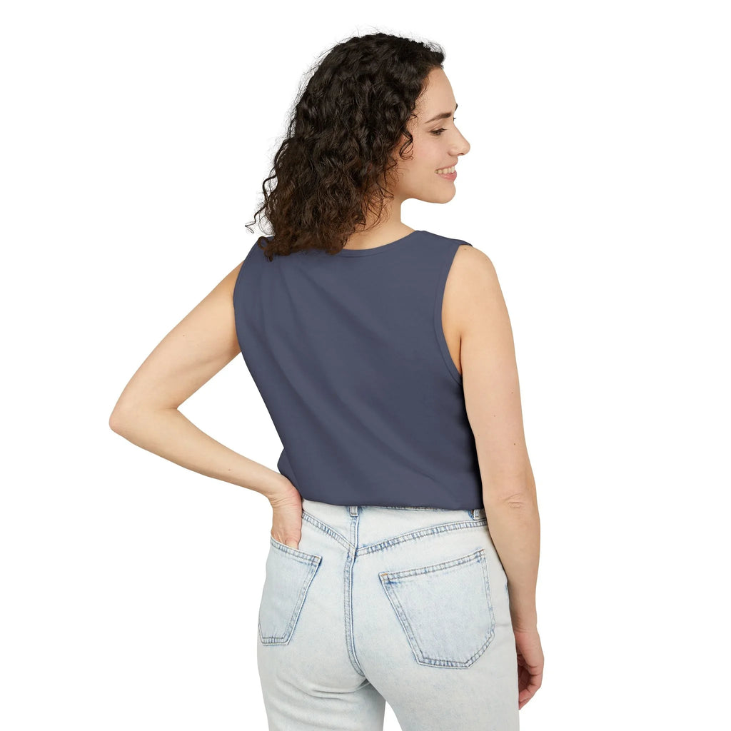 Woman in sleeveless navy top and light blue jeans smiling, shown from the back