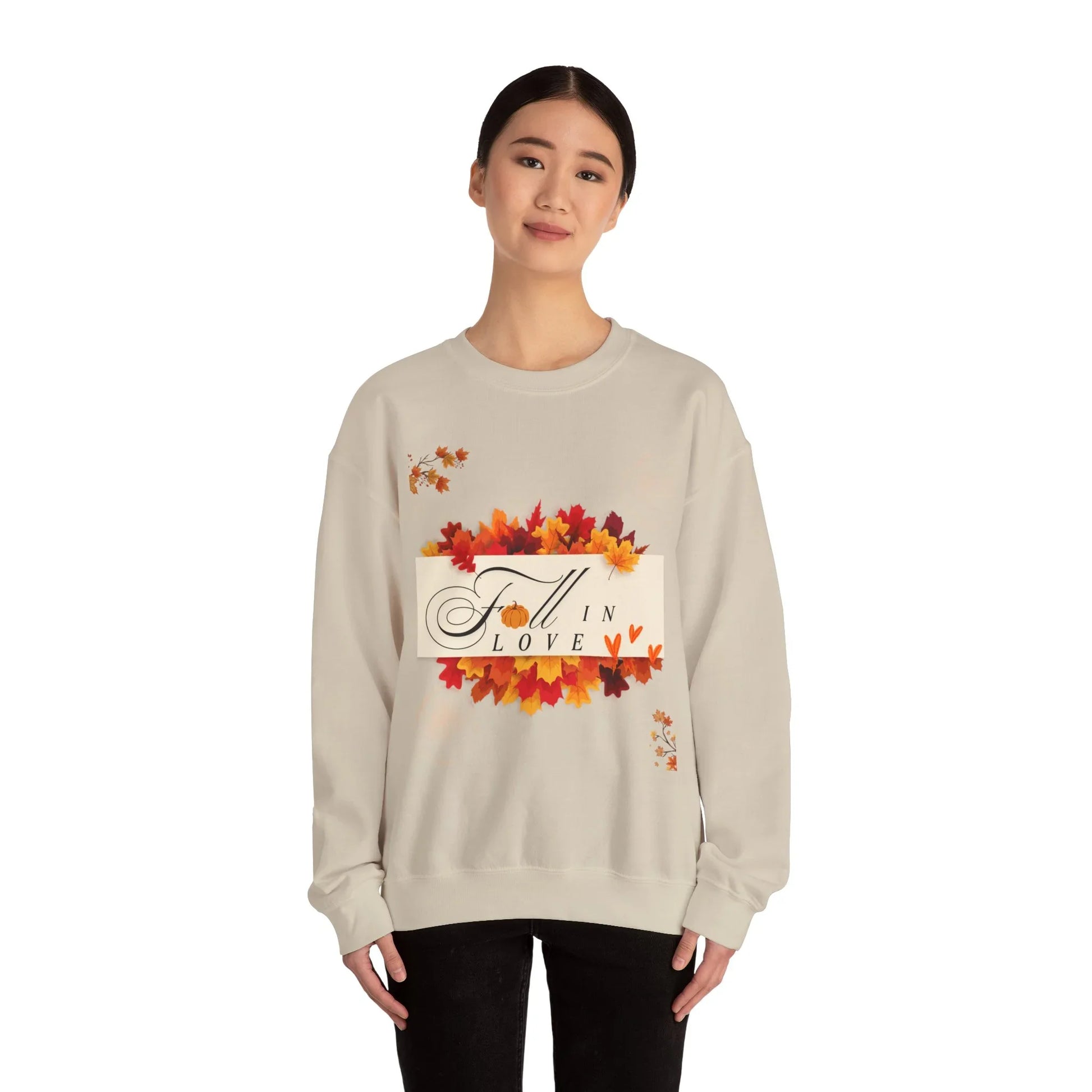 Woman wearing beige Fall in Love sweatshirt with autumn leaves design on white background