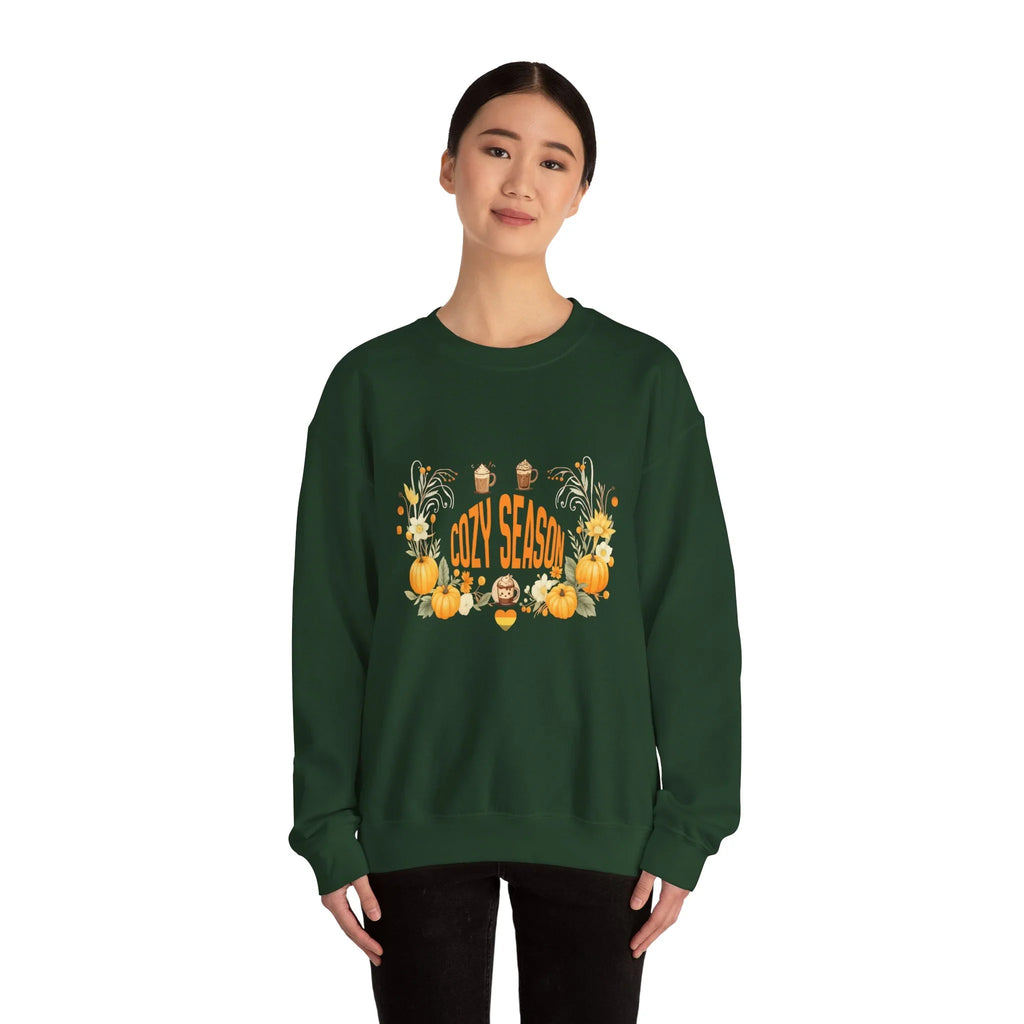 Woman wearing green sweatshirt with 'Cozy Season' pumpkin and autumn floral design