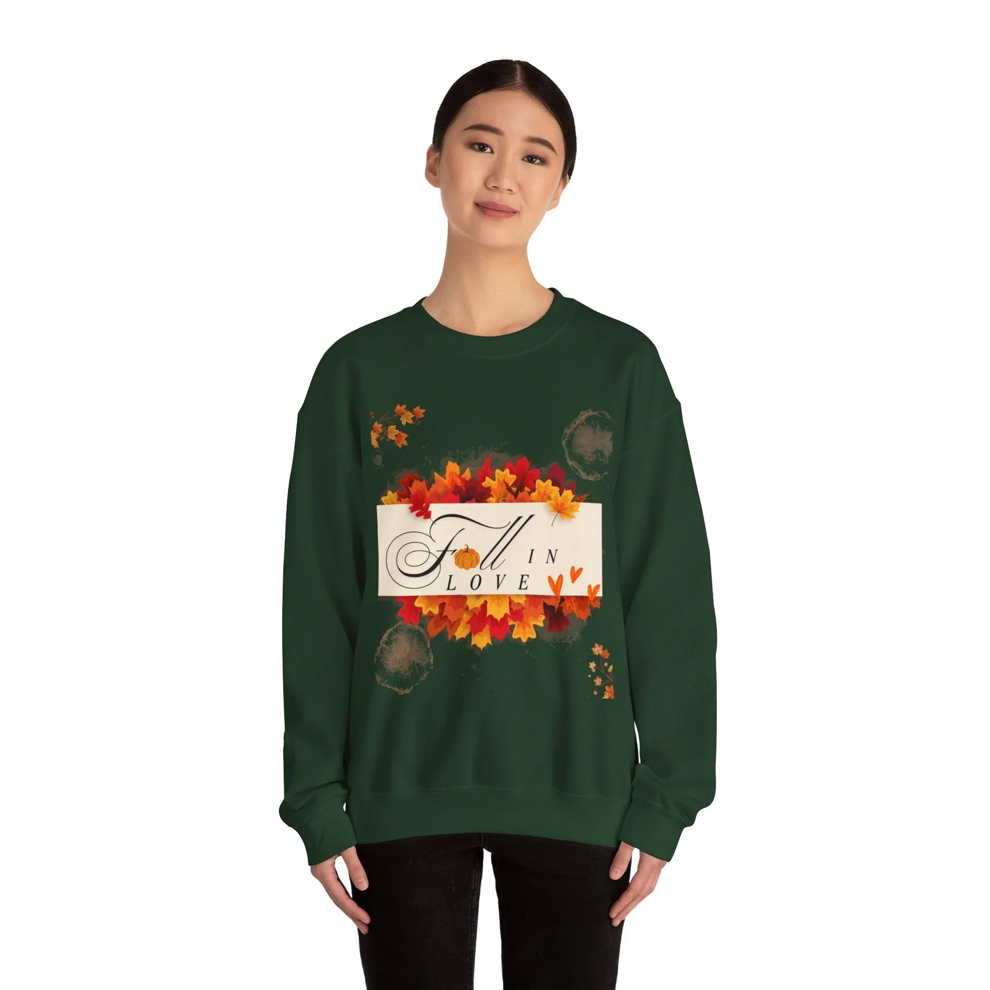 Woman wearing green fall sweatshirt with 'Fall in Love' and autumn leaves design