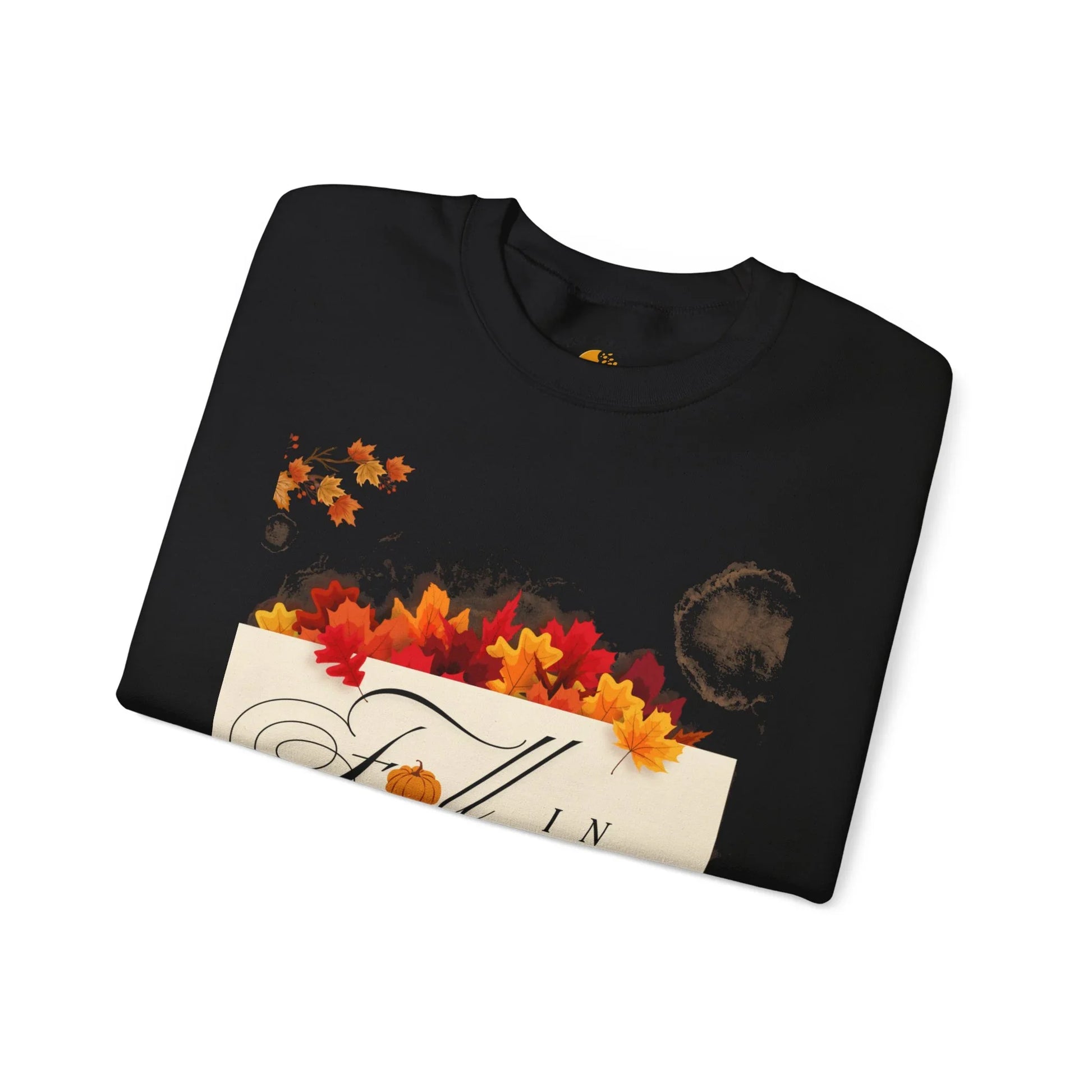 Folded black fall-themed t-shirt with orange and red autumn leaves and festive design