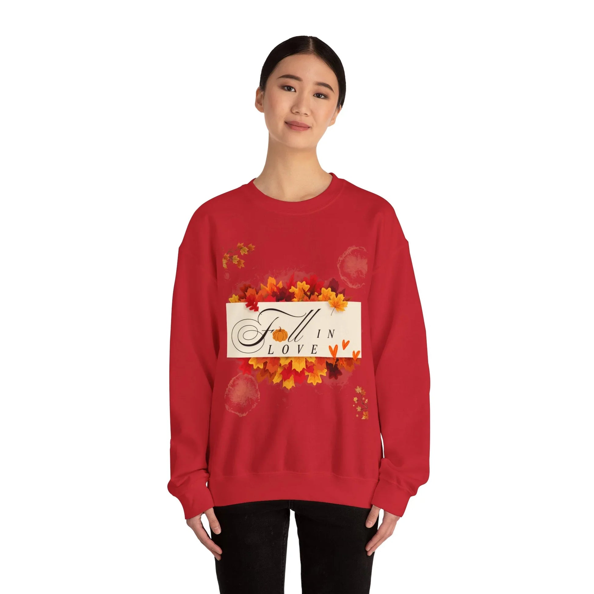 Woman wearing red sweatshirt with fall leaves and 'Fall in Love' design on front