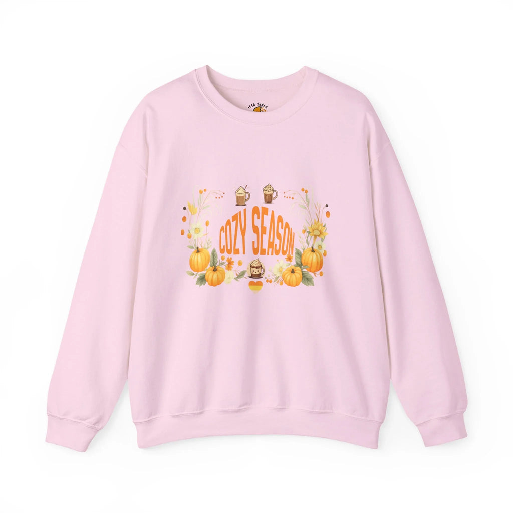 Pink sweatshirt with 'Cozy Season' text, pumpkins, sunflowers, and fall drinks graphic.