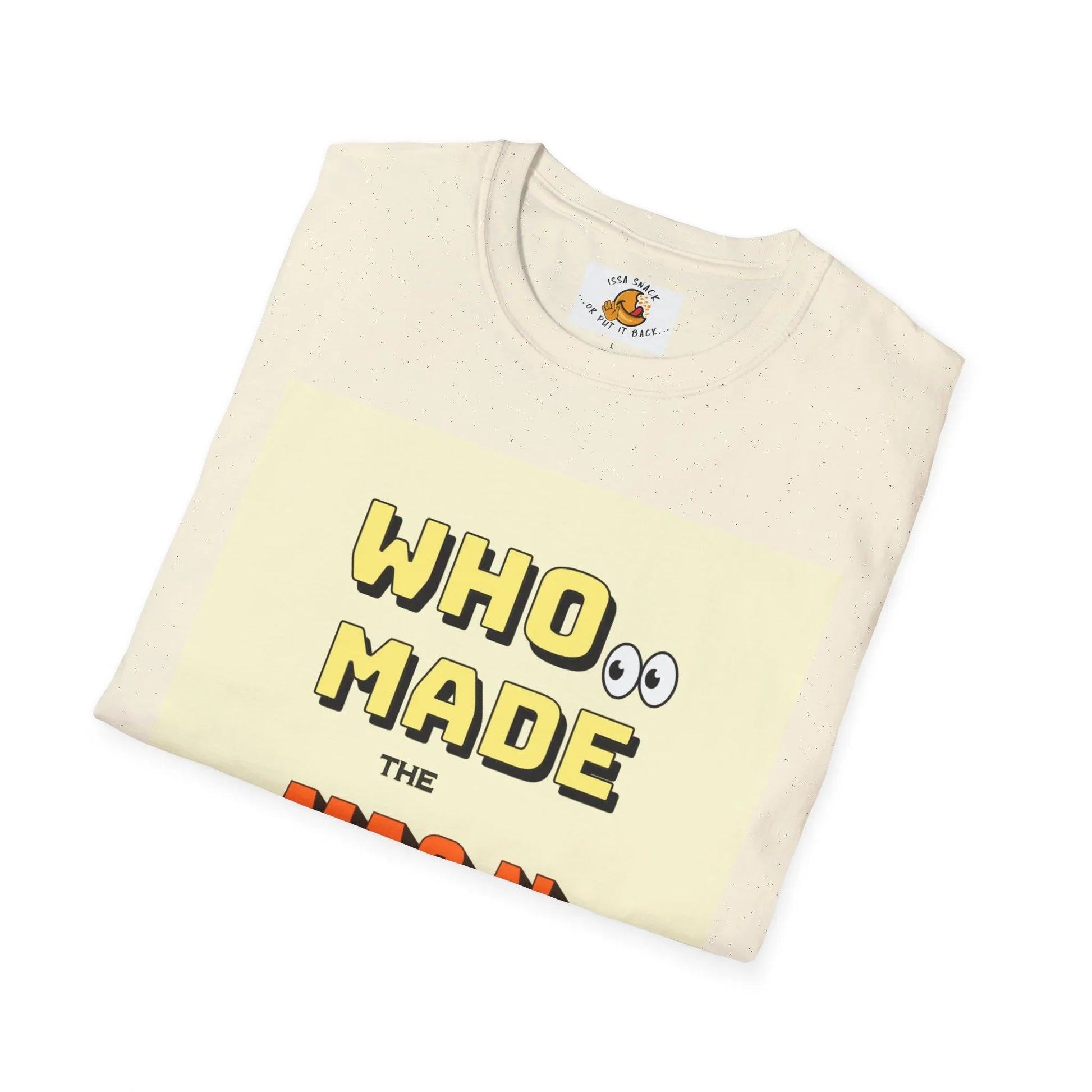 Folded cream t-shirt with bold yellow text reading 'WHO MADE' and cartoon eyes, flat lay.